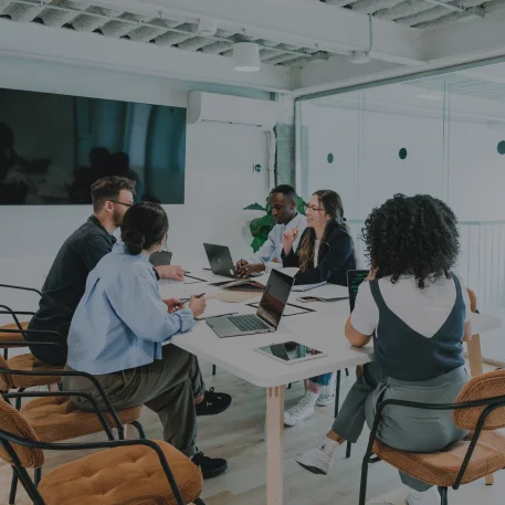 Professional team of IT consultants collaborating on digital banking and fintech solutions in an office setting