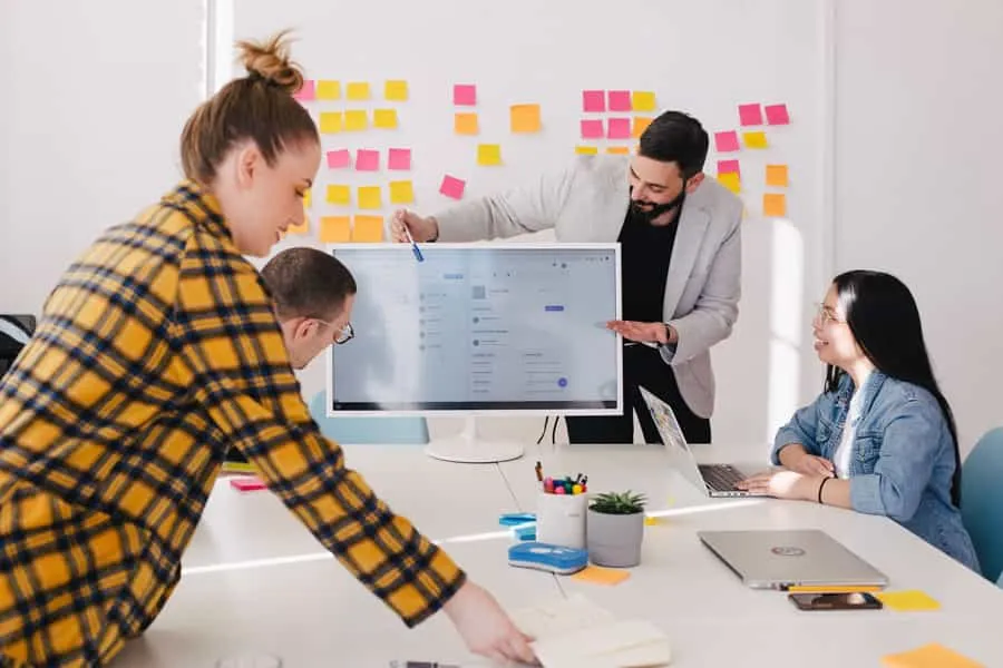 Agile project managers and developers planning fintech solution workflows on a sticky note board