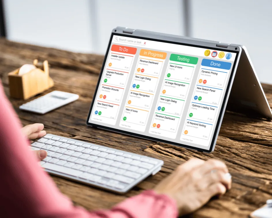 Professional using a digital tablet displaying project management dashboards and agile delivery metrics for FiNLean CRM implementations