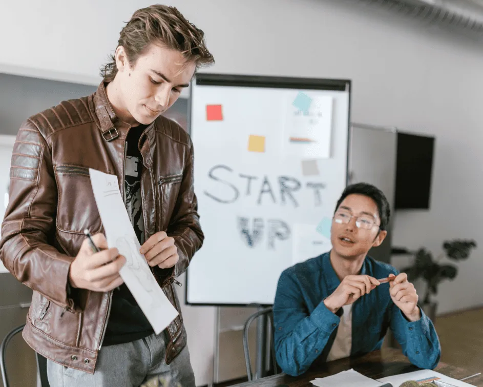 Business consultants and technology strategists planning digital transformation on a whiteboard