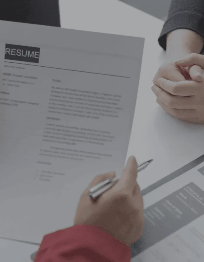 Job applicant holding a resume during an interview for a Microsoft Dynamics 365 and fintech career at FiNASAL